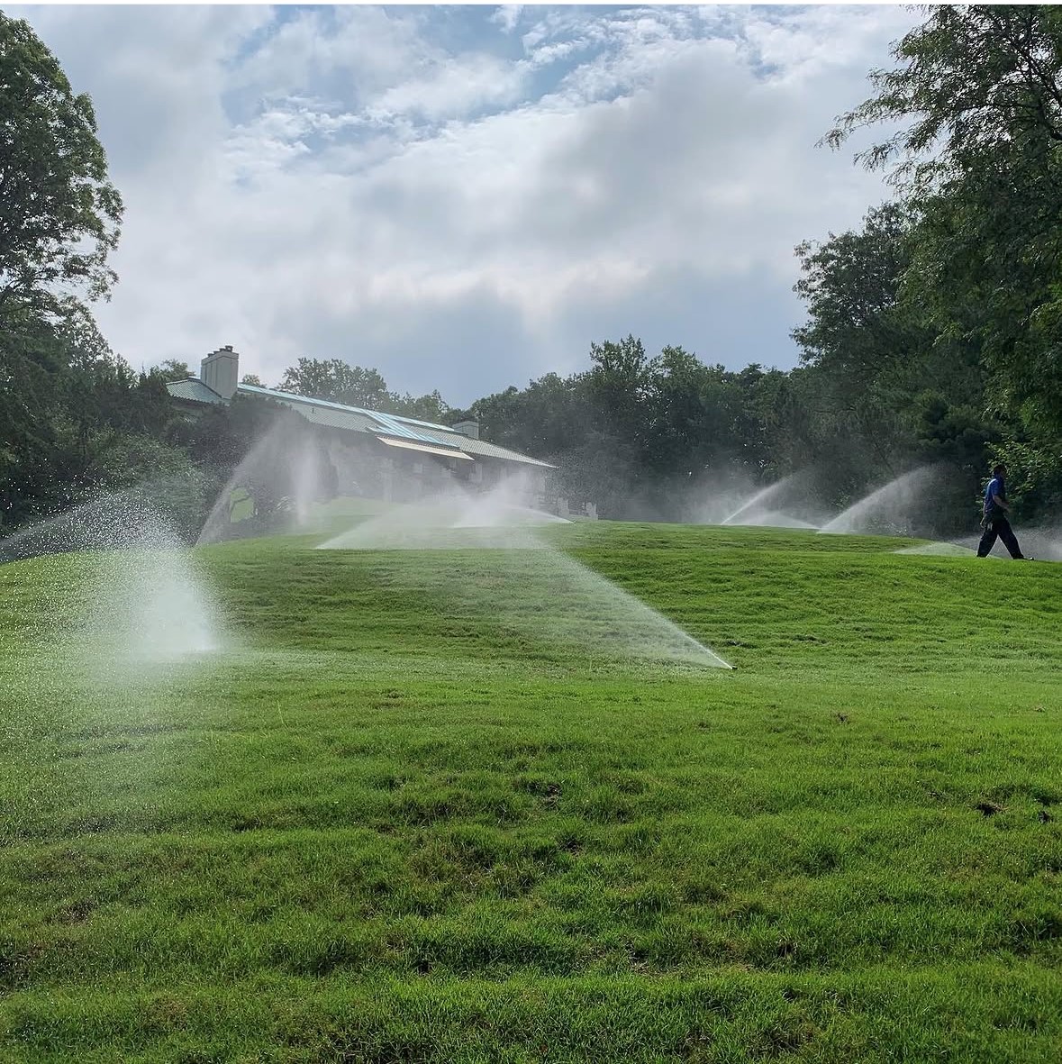 Sprinklers watering a lawn during a Garden State coverage check
