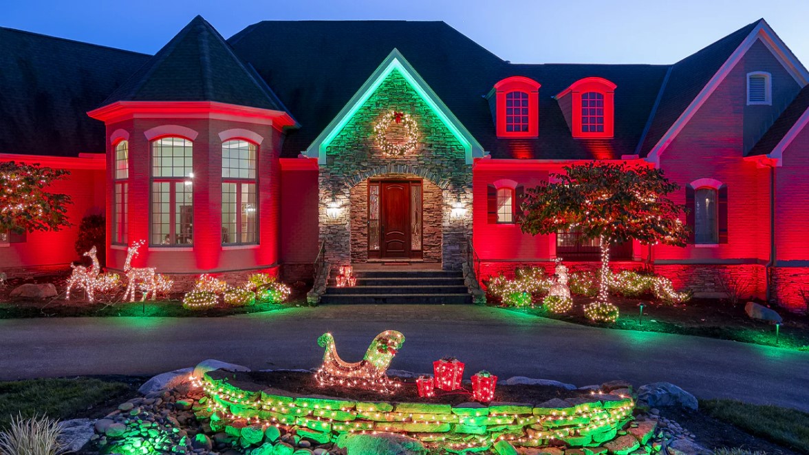 Red and green holiday lighting across a home