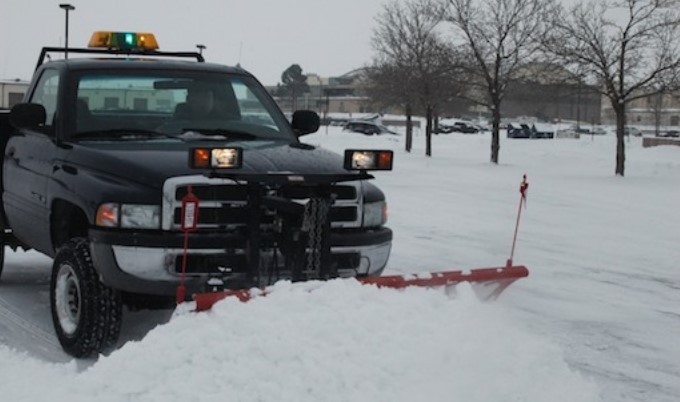 Snow plow clearing a residential driveway